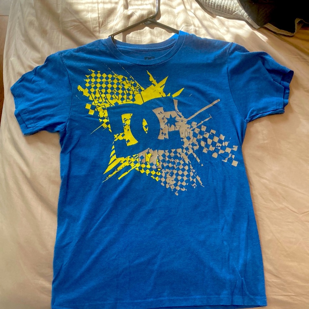 A blue small DC T-shirt.